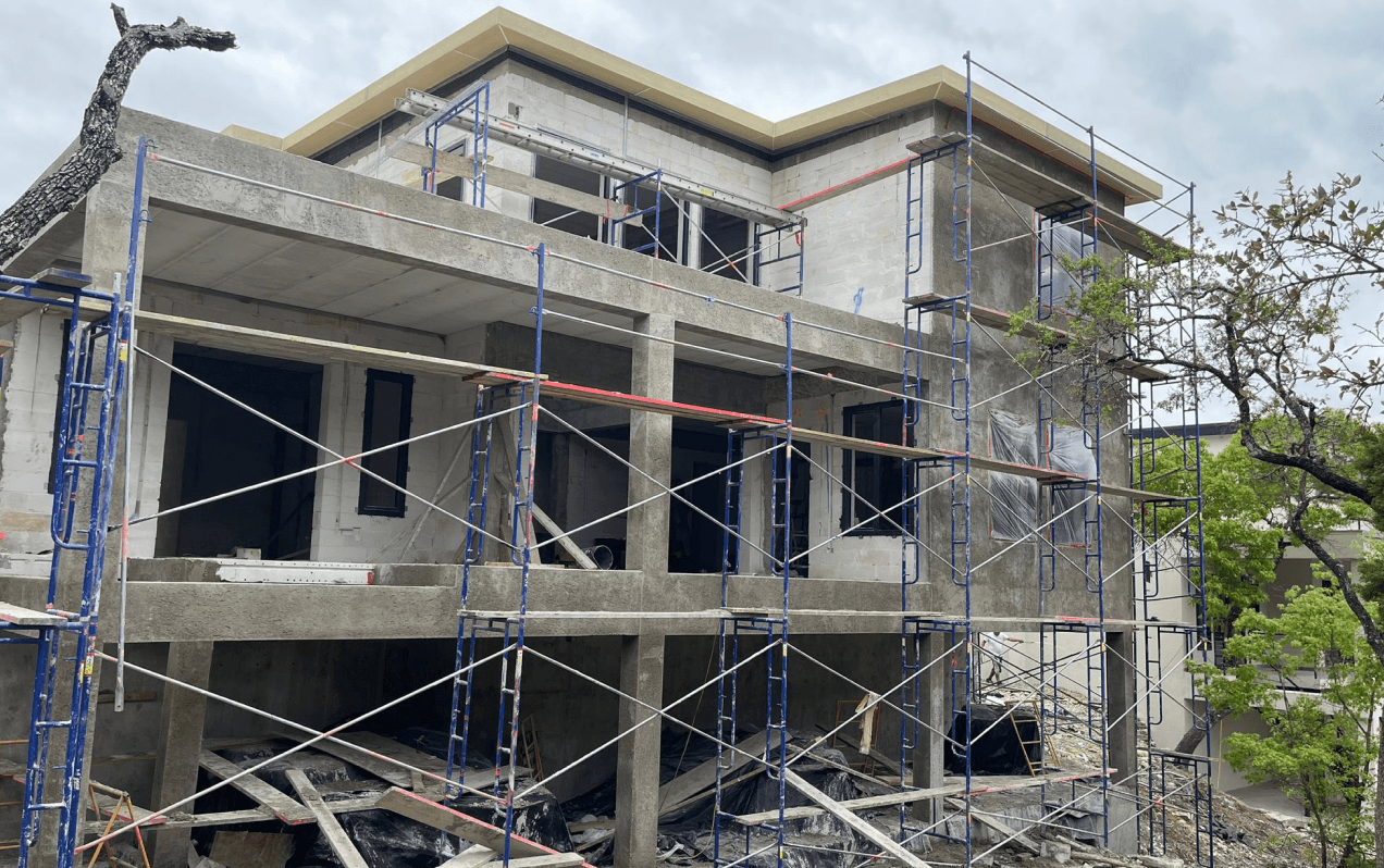 AAC concrete home under construction with scaffolding and block walls being installed