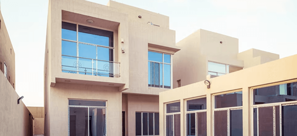 Modern AAC concrete home exterior with flat roof, balcony, and stucco finish