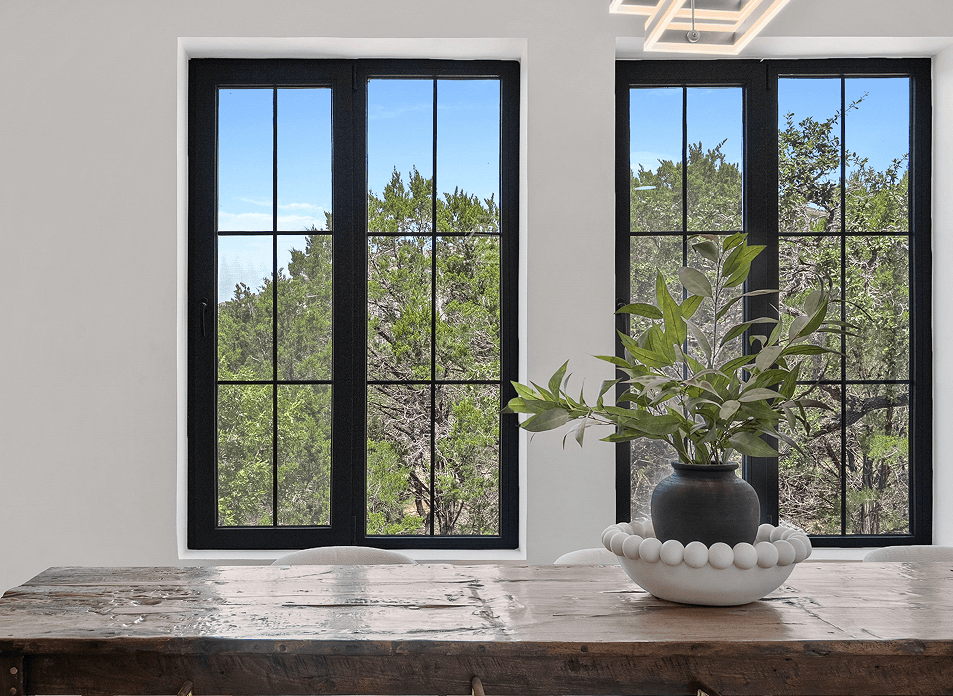 Interior of an AAC concrete home with natural light, black-framed windows, and modern finishes