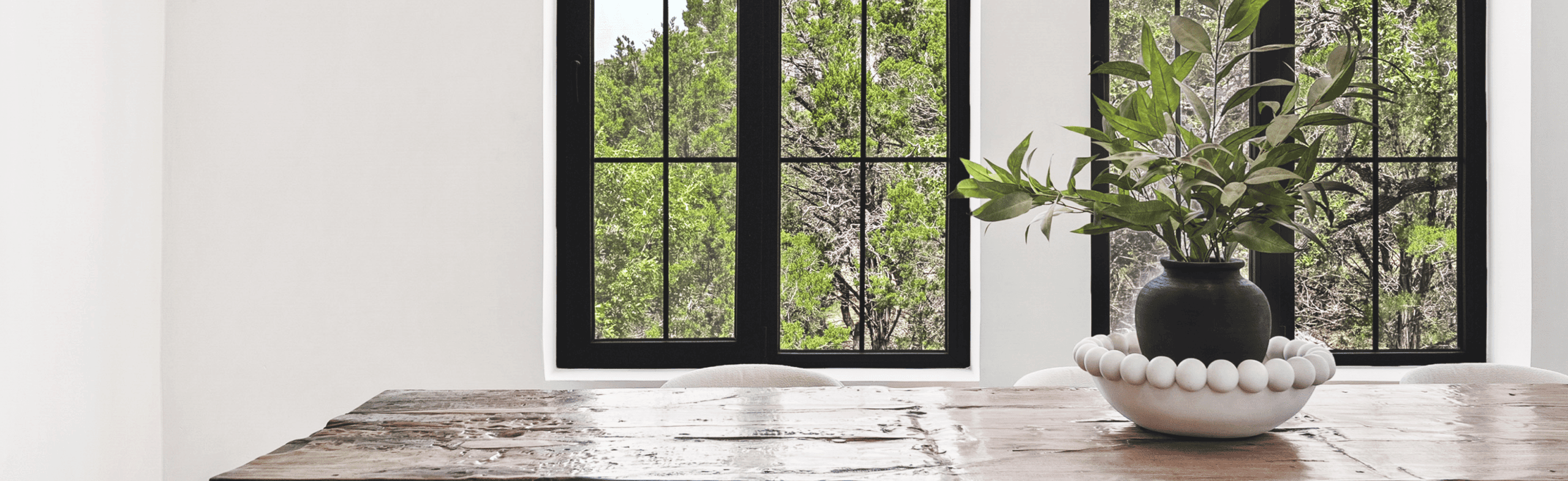 Interior of an AAC concrete home with natural light, black-framed windows, and modern finishes