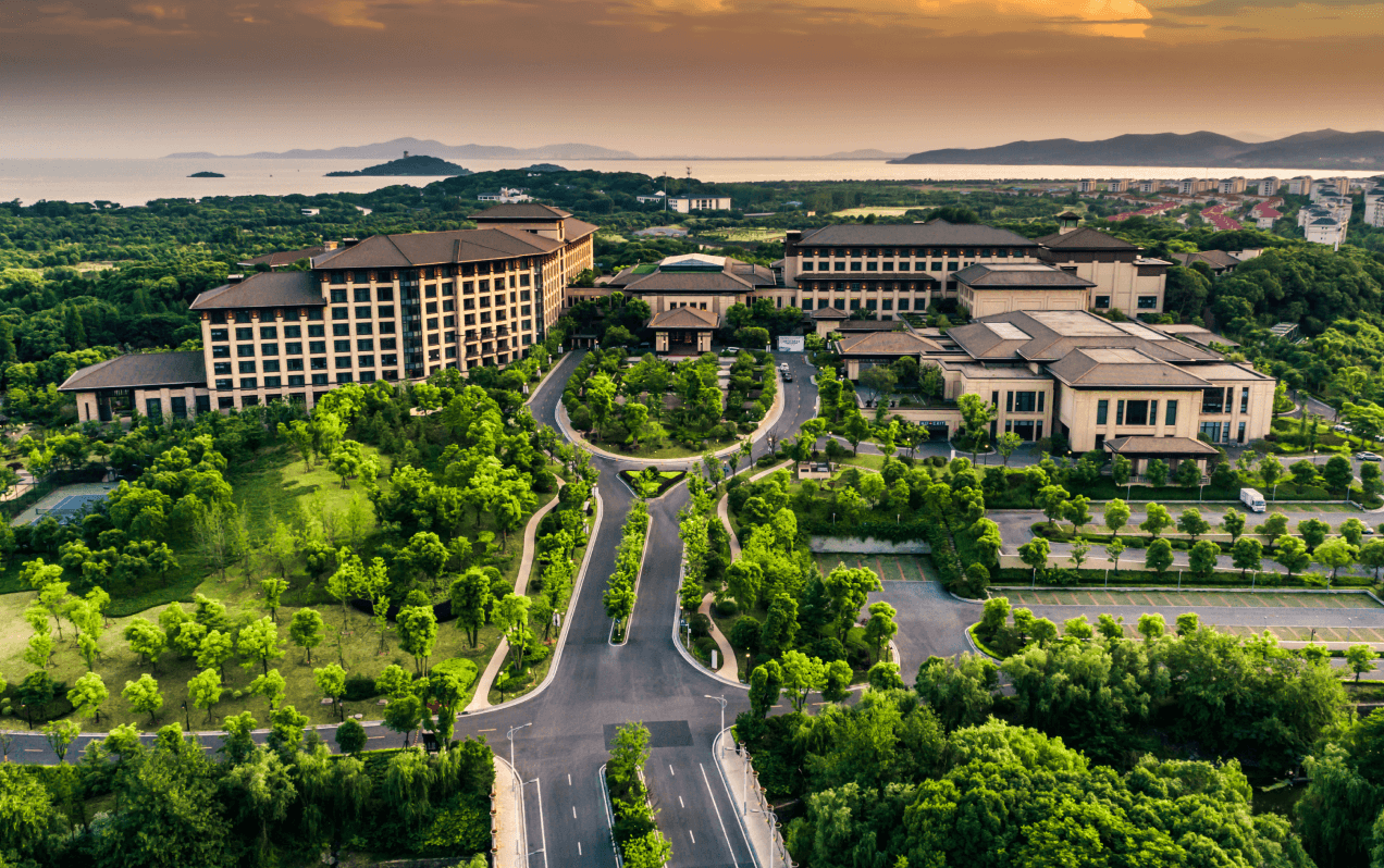 Aerial view of a large-scale concrete construction development with landscaped grounds